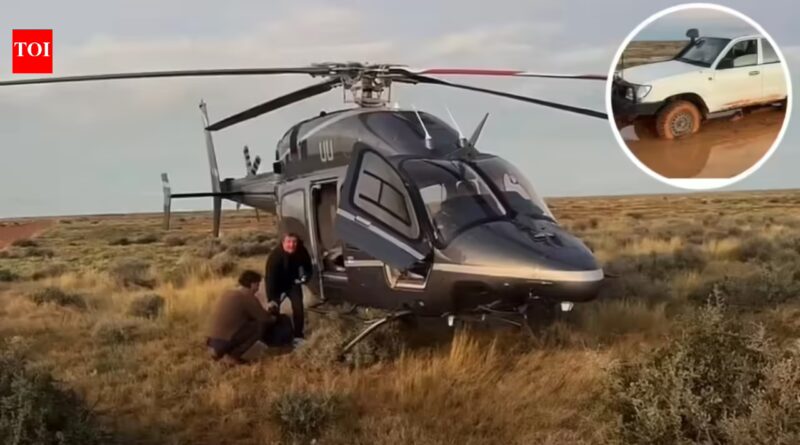 Australian father and son were stranded in the outback for 12 hours after a storm trapped their car; billionaire Tim Roberts, who happened to be flying his helicopter, rescued them